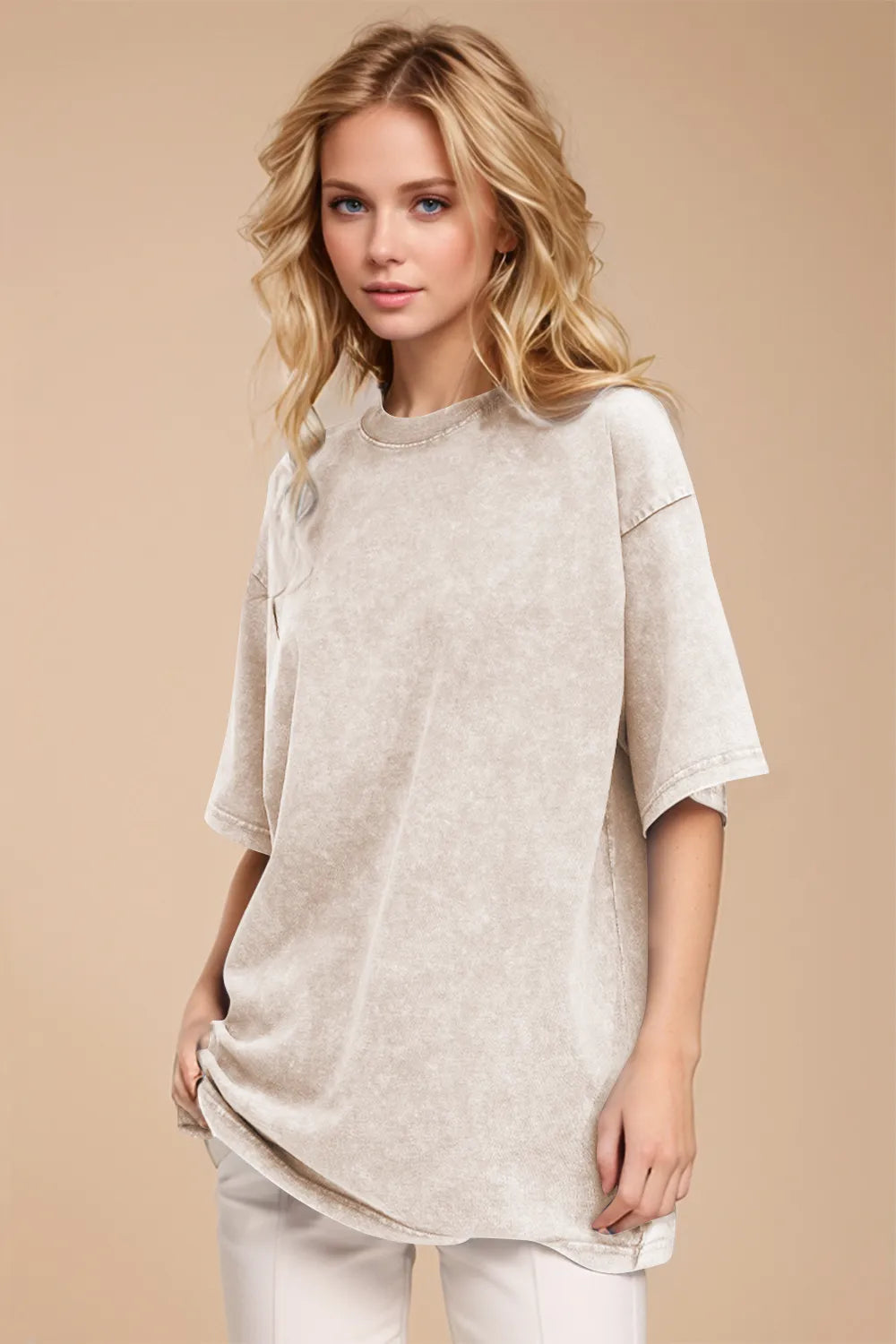Woman wearing a beige oversized shirt and white pants on a beige background
