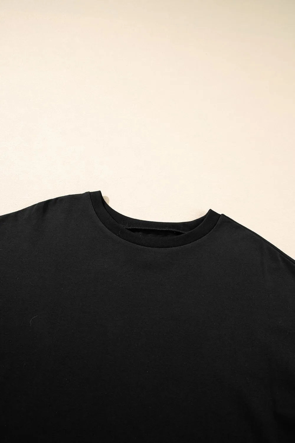 Black t-shirt on a beige background