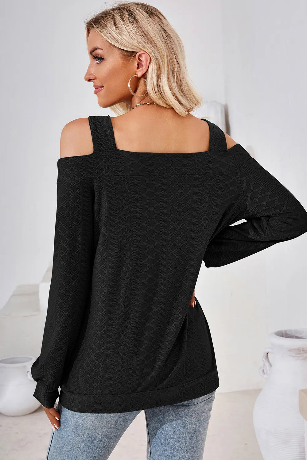 Back view of black cut out square neck cold shoulder top with elegant long sleeve design