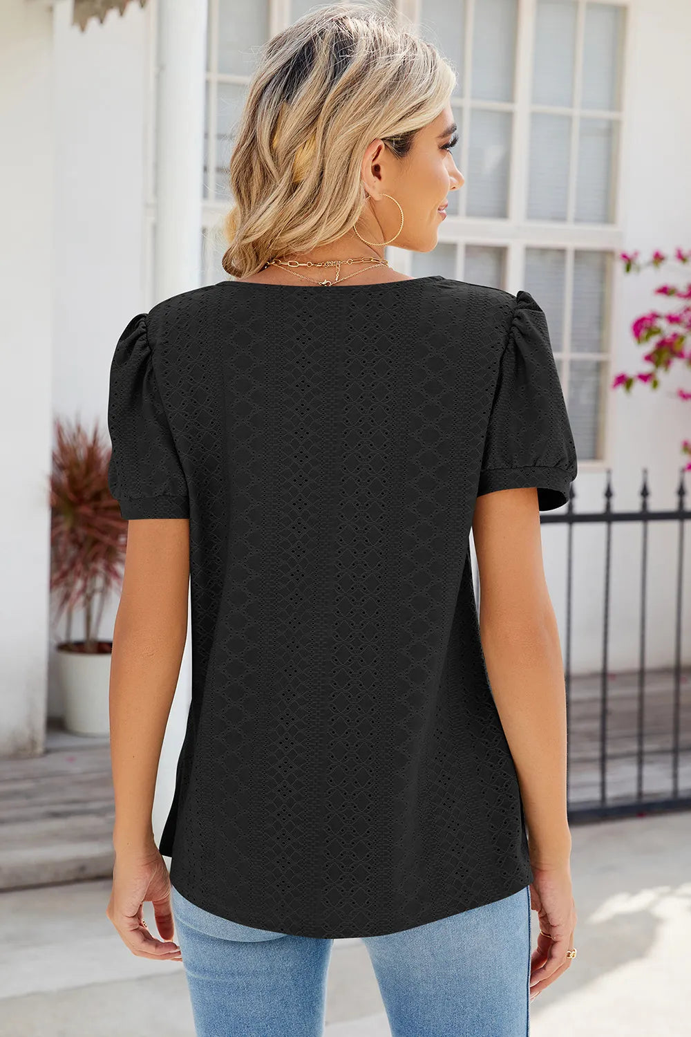 Black broderie anglaise top with eyelet embroidery and elegant casual design