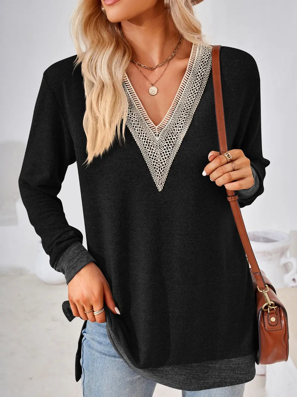 Black crochet contrast V neck long sleeve top with elegant lace accents and side slit design