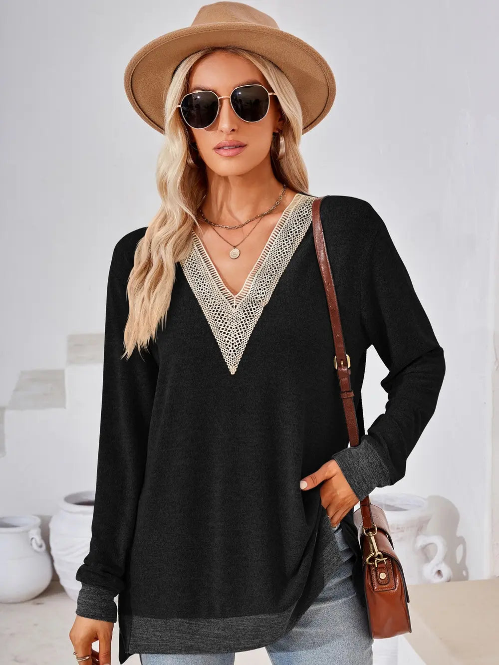Black V neck long sleeve top featuring crochet contrast details and flattering fit