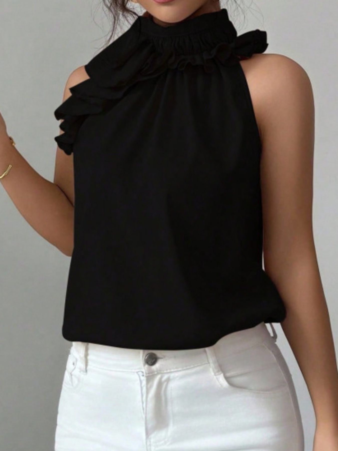 Black sleeveless summer blouse with feminine ruffle neckline and lightweight construction