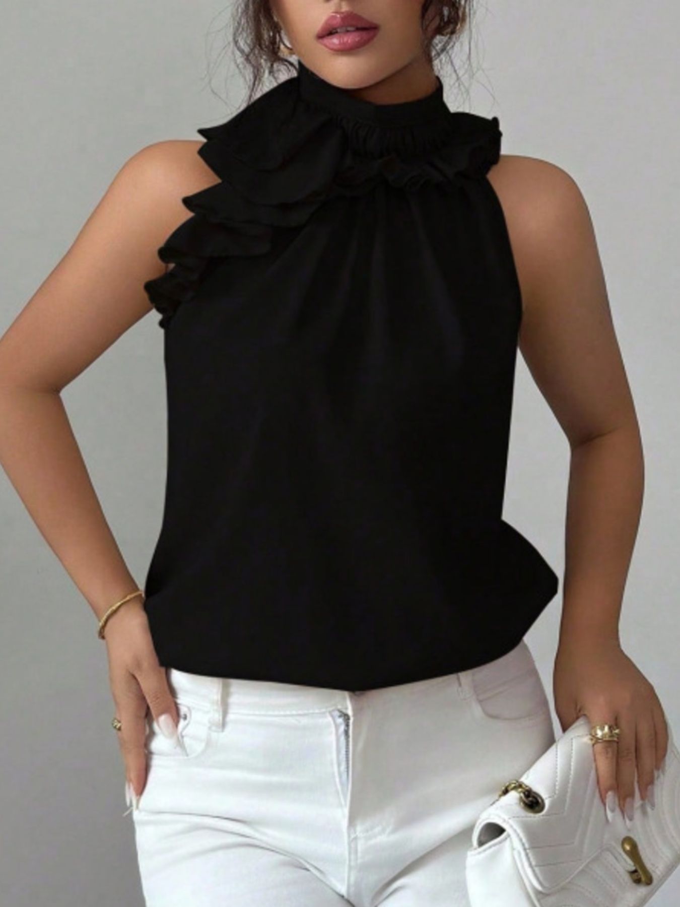 Smart casual black sleeveless top with front buttons and stylish ruffle neck detail