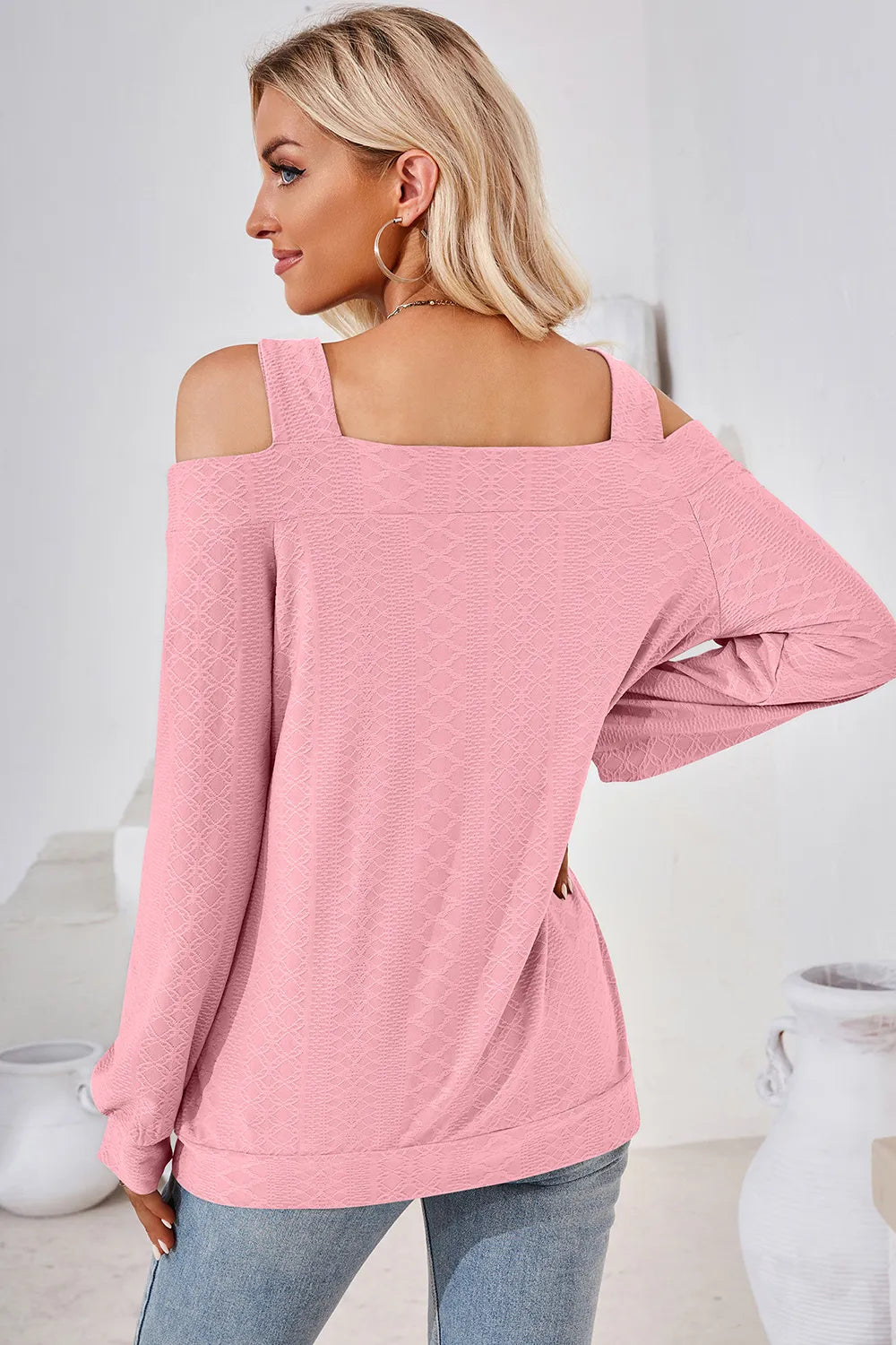 Back view of blush pink cut out square neck cold shoulder top with long sleeves