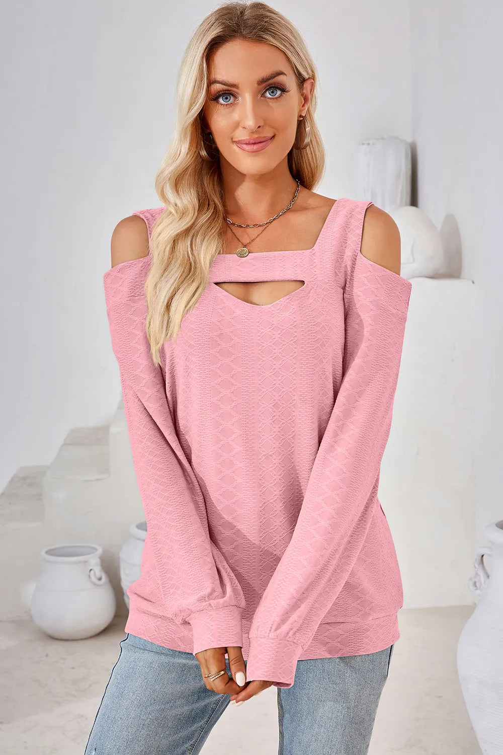 Blush pink long sleeve cold shoulder top featuring square neckline and shoulder cut out detail