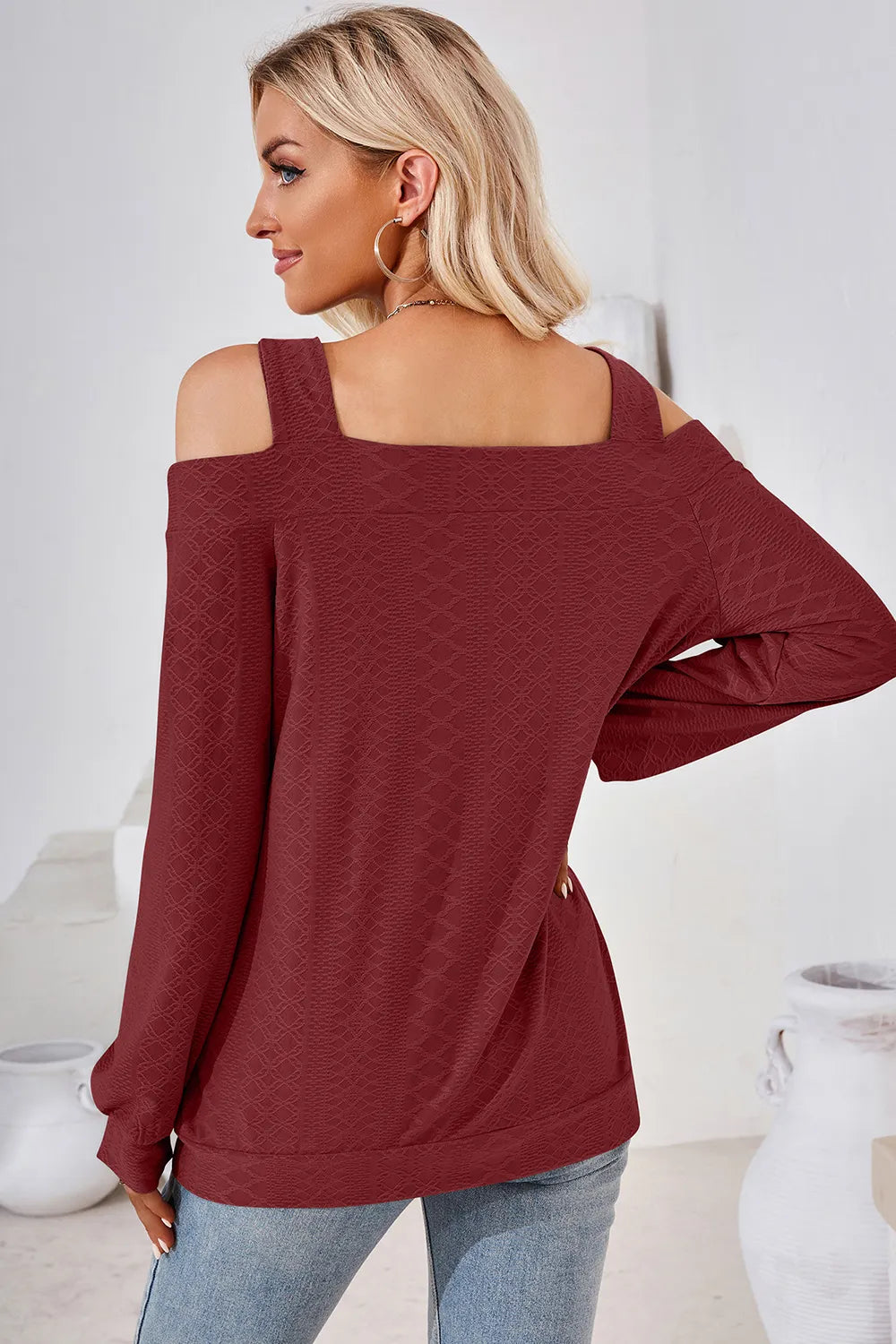 Back view of burgundy cut out square neck cold shoulder top with long sleeve styling