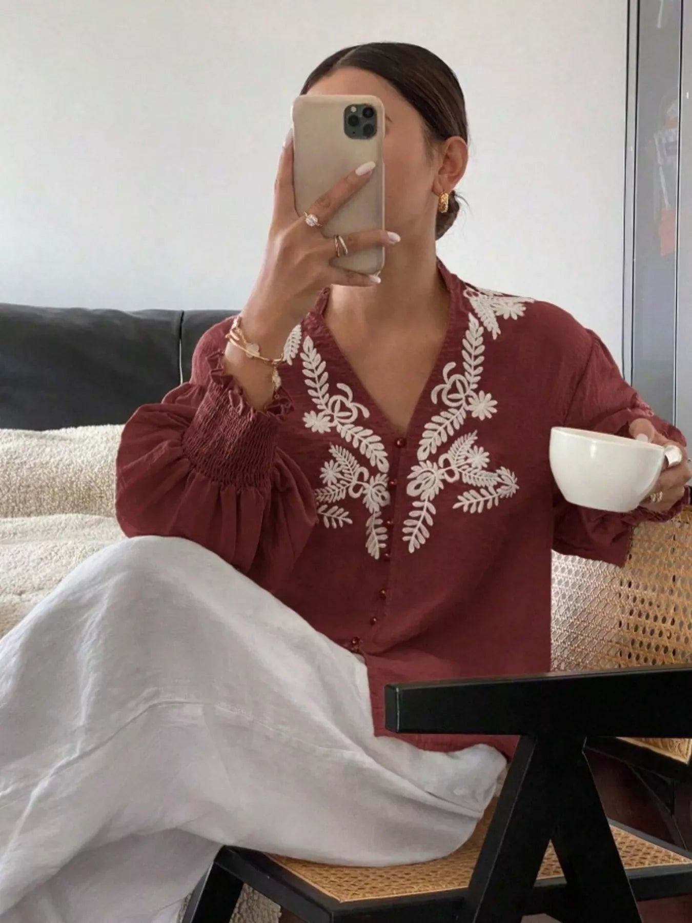 Burgundy embroidered button front blouse close up highlighting intricate embroidery details