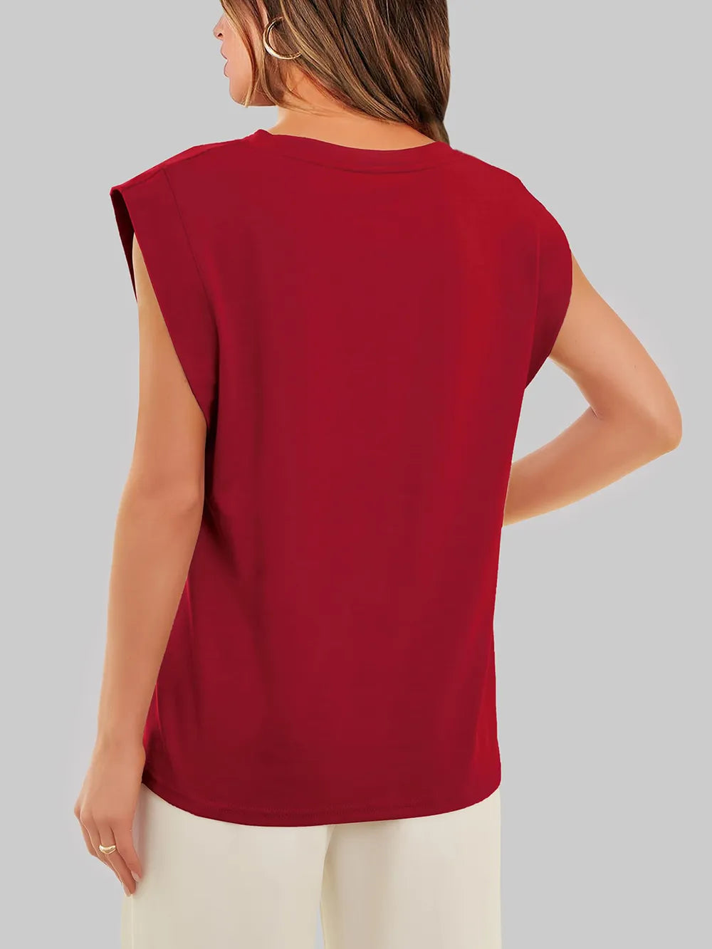 Red sleeveless top worn by a person on a gray background