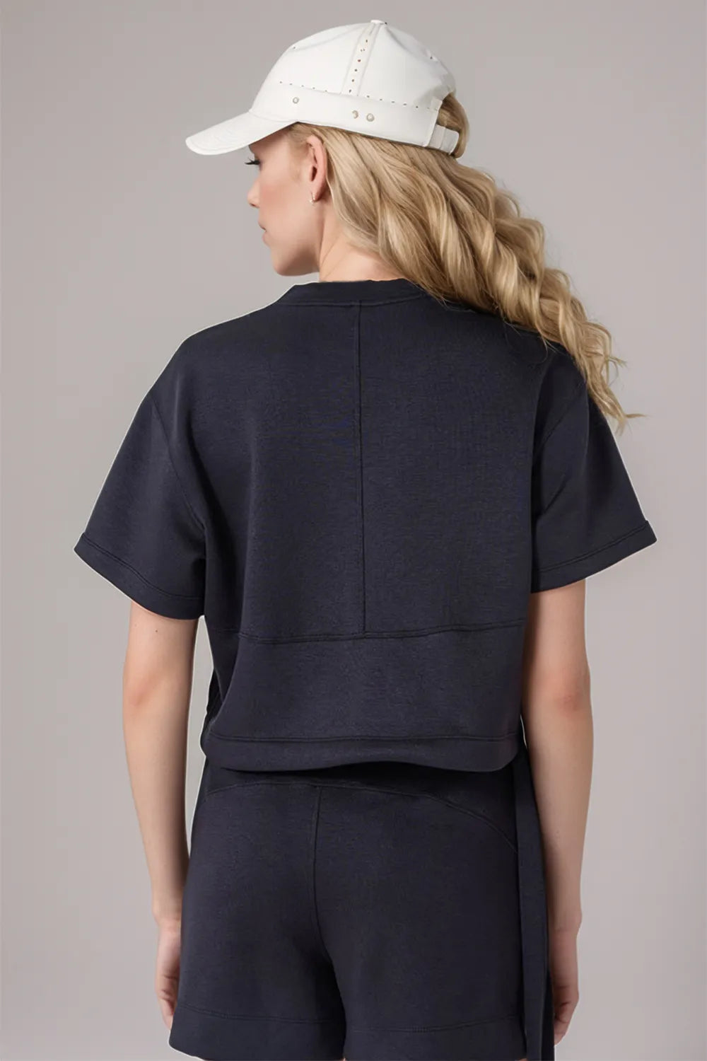 Back view of drawstring hem scuba round neck t-shirt showcasing relaxed silhouette and adjustable hem detail for women