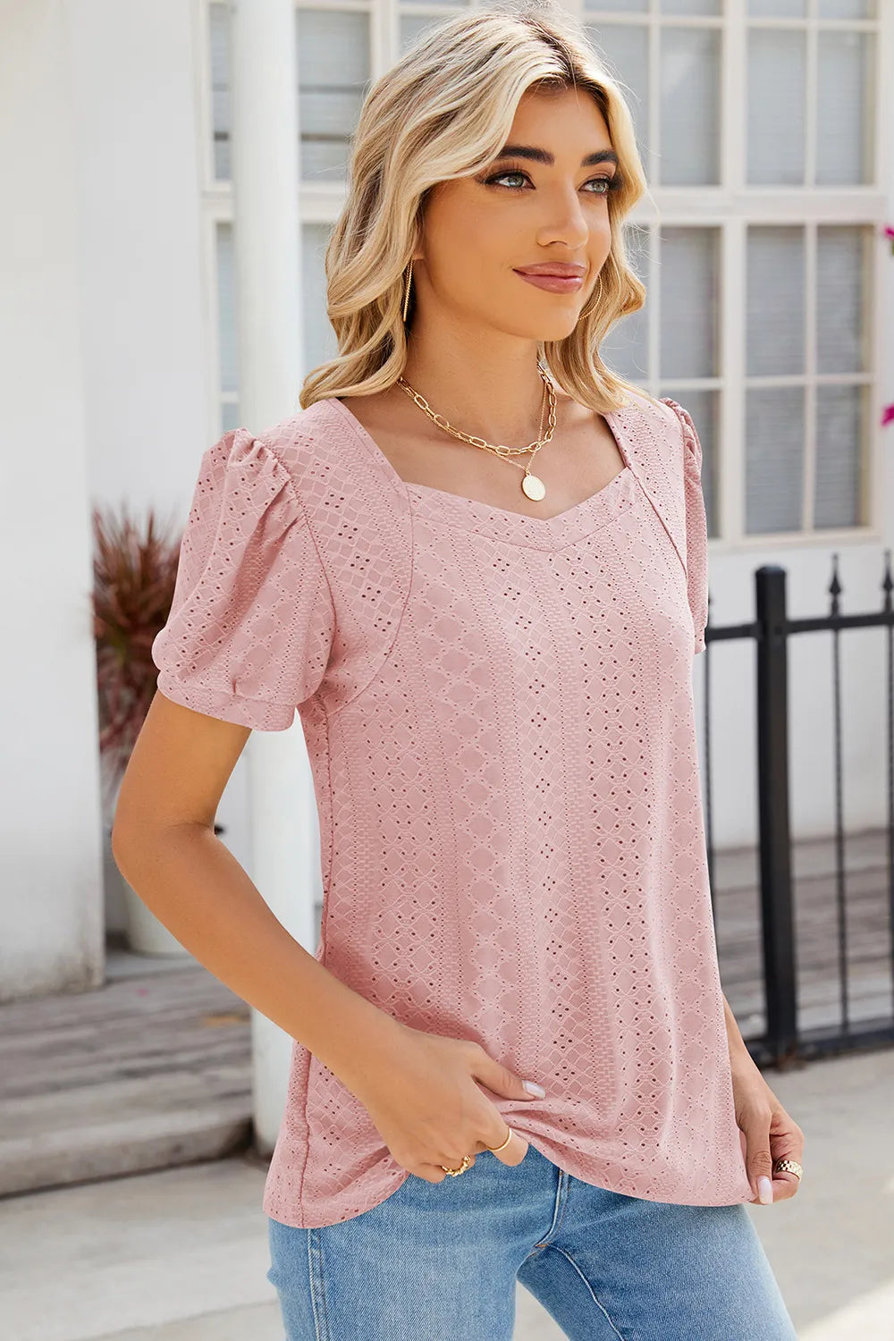 Dusty pink eyelet top with feminine puff sleeves and versatile everyday appeal