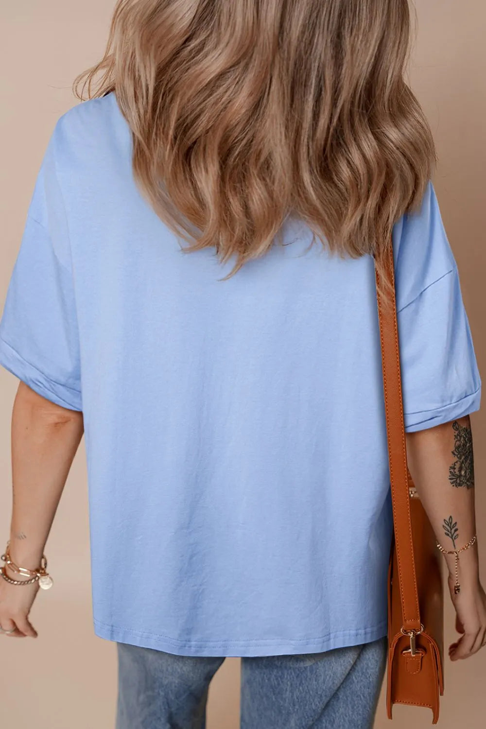 Light blue loose half sleeve t-shirt with hi-low hem angled view comfortable women's everyday clothing