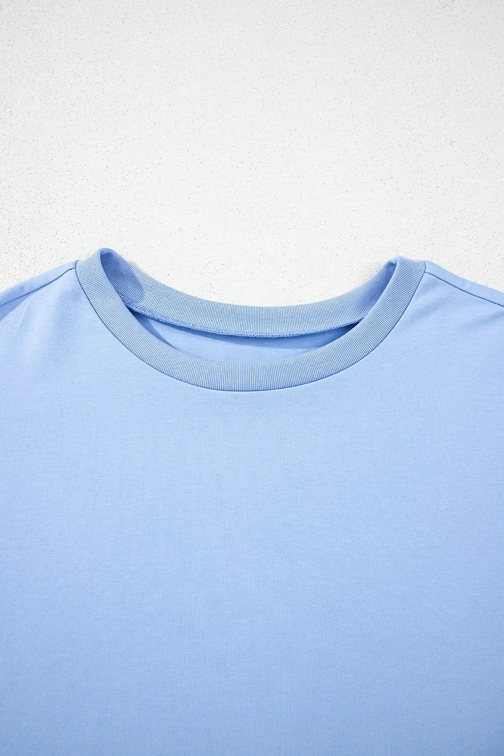Light blue hi-low hem t-shirt styled for casual everyday wear with relaxed women's fit