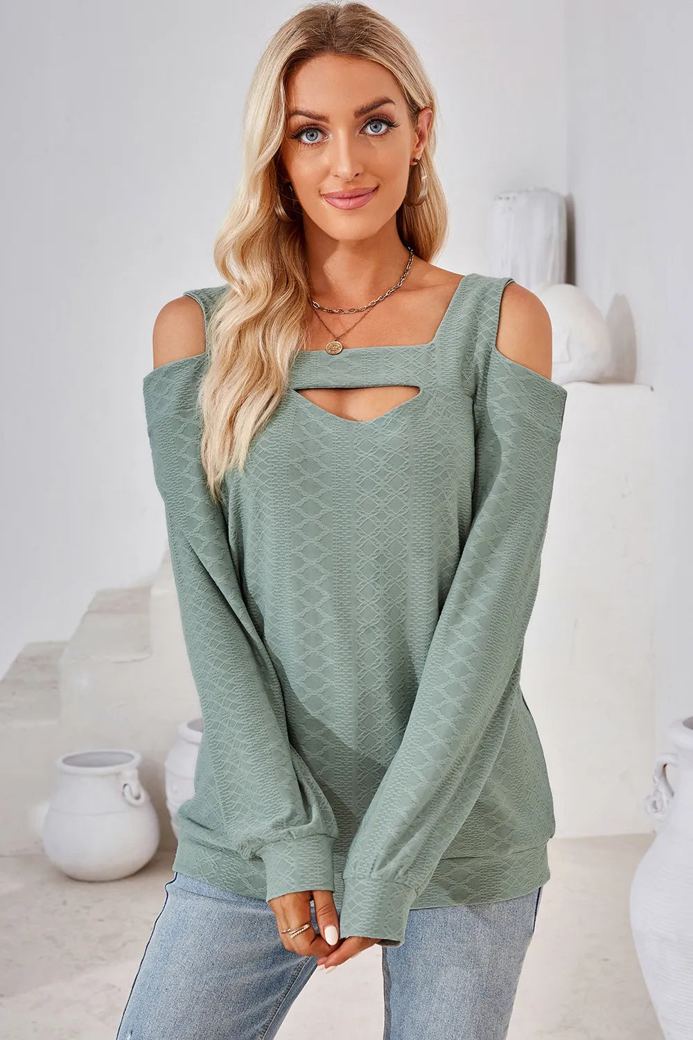 Light green long sleeve cold shoulder top featuring square neckline and cut out shoulder detail