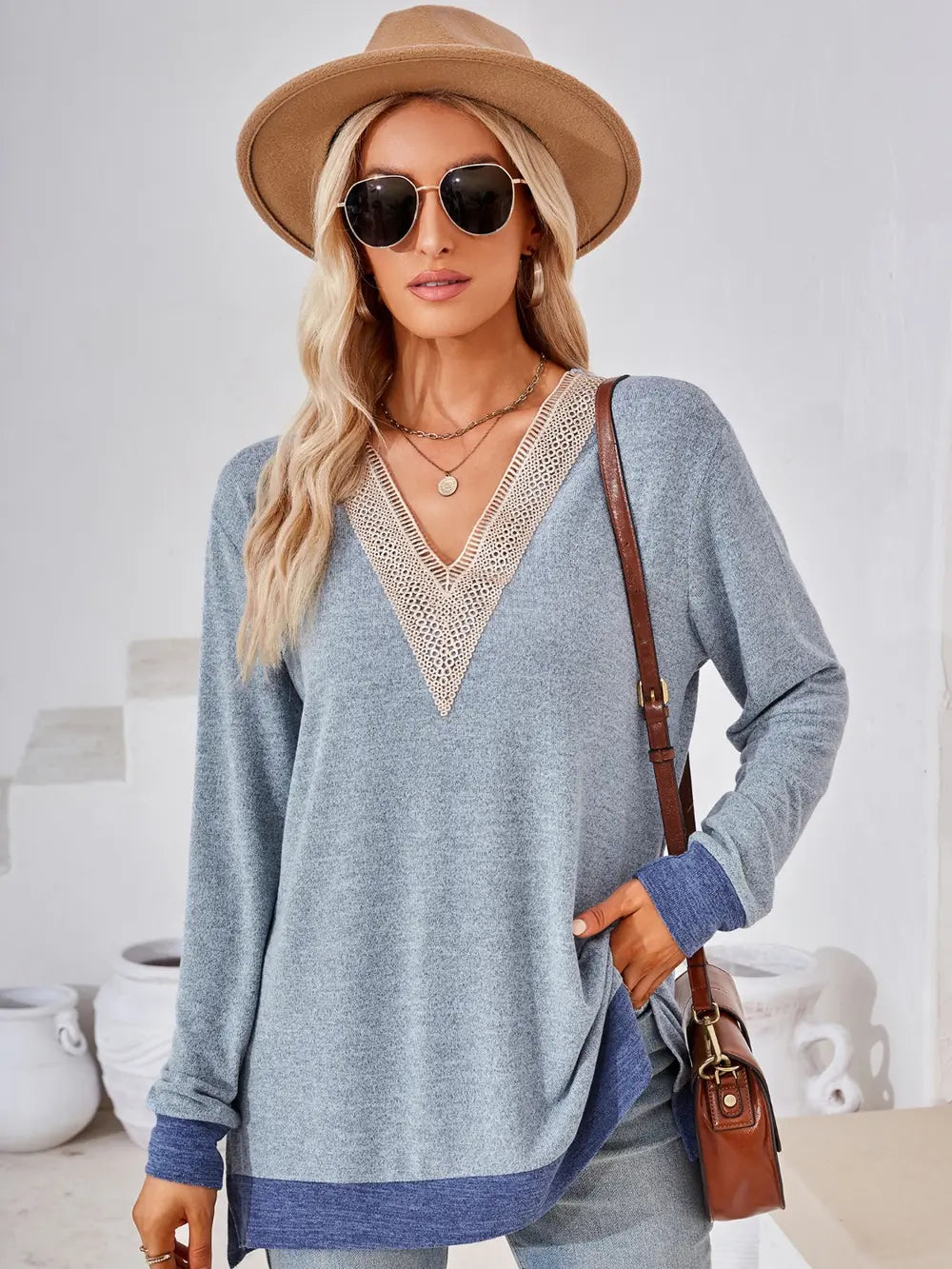 Misty blue V neck long sleeve top featuring crochet contrast accents and flattering silhouette