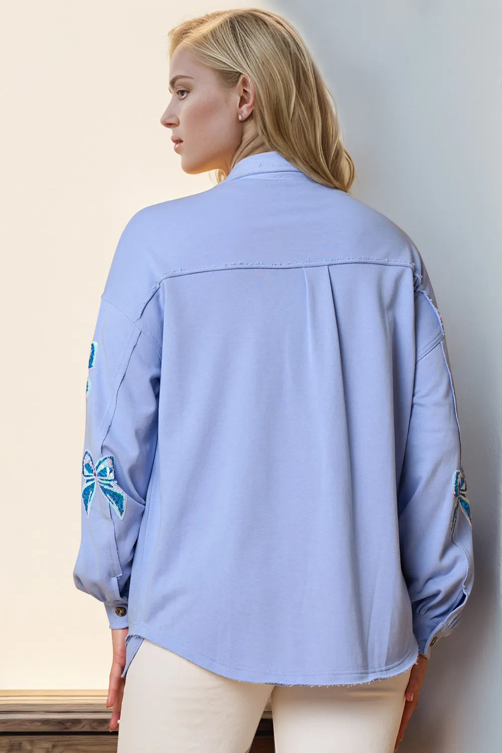 Plus size sequin bow button-up shacket angled view stylish women's layering piece for casual and party wear