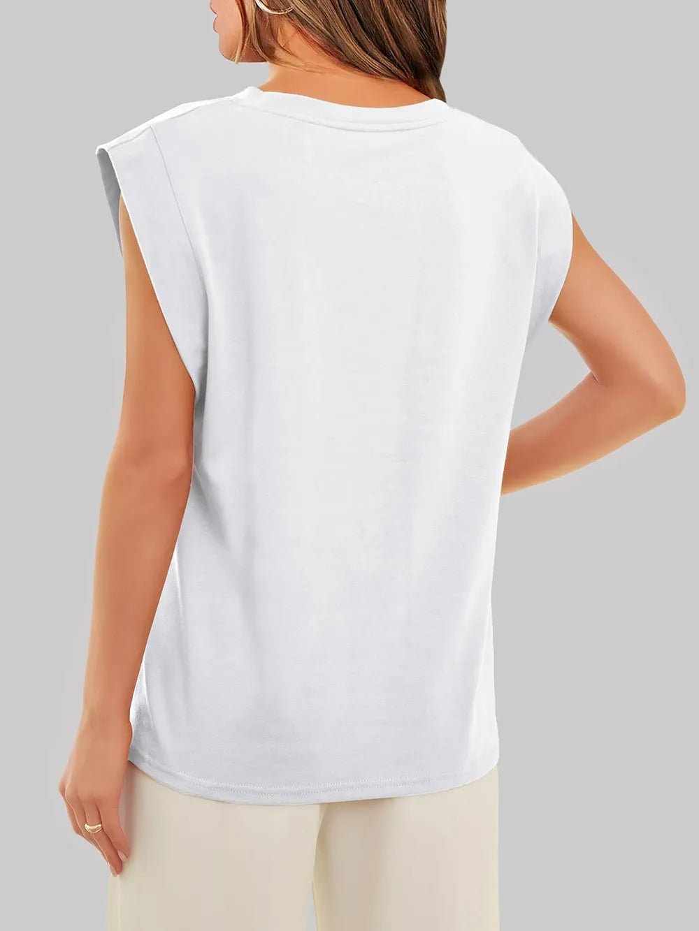 White sleeveless top worn by a person on a gray background
