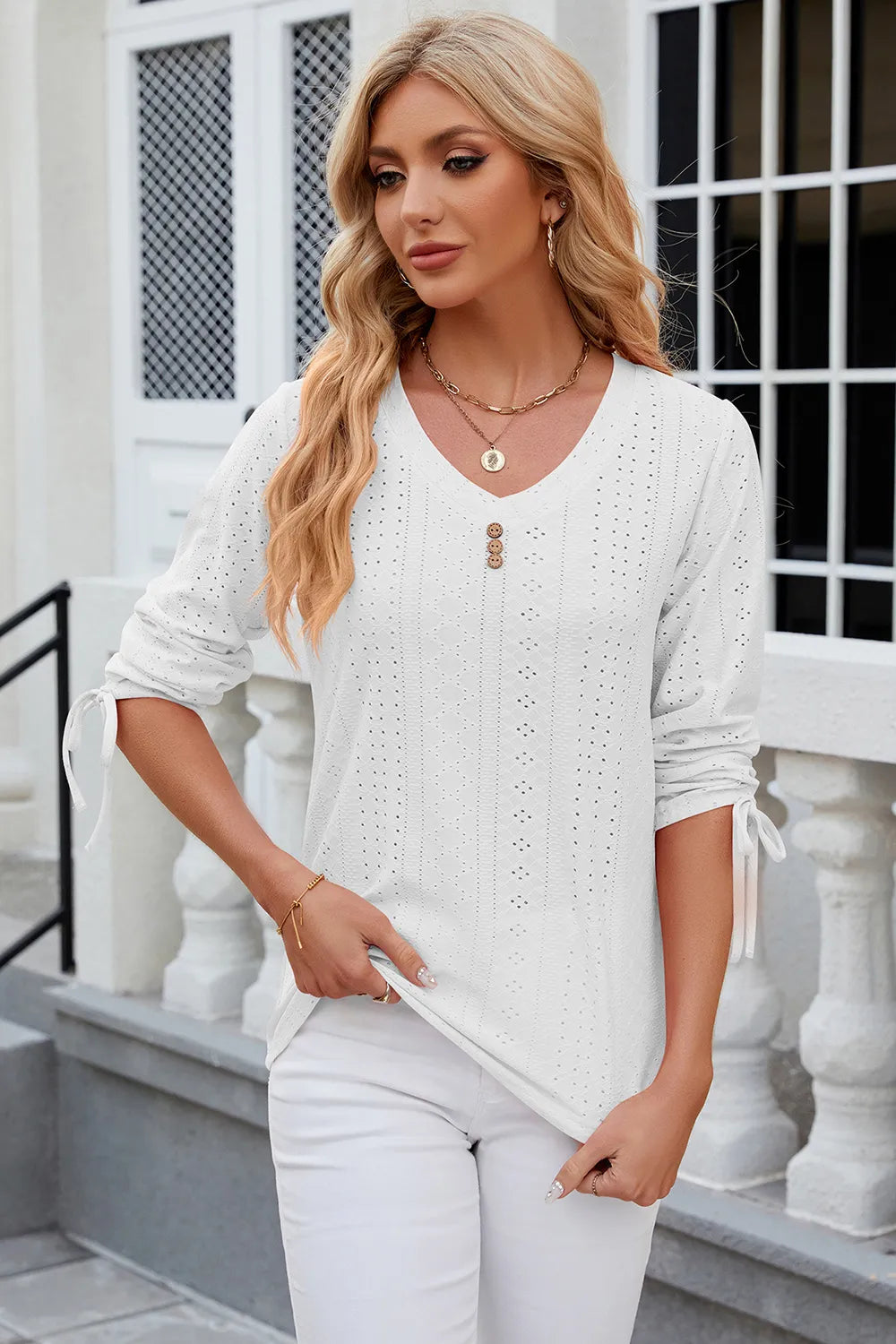White half sleeve blouse featuring eyelet embroidery and adjustable drawstring neckline