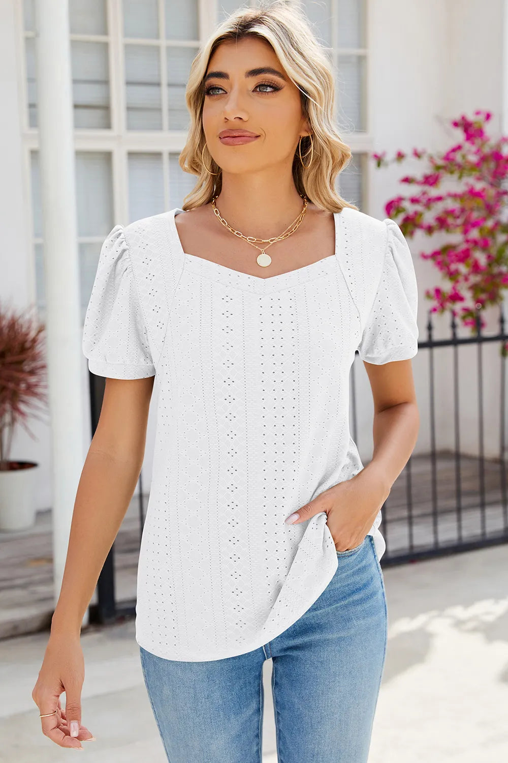 White embroidered eyelet blouse featuring puff sleeves and breathable cotton feel