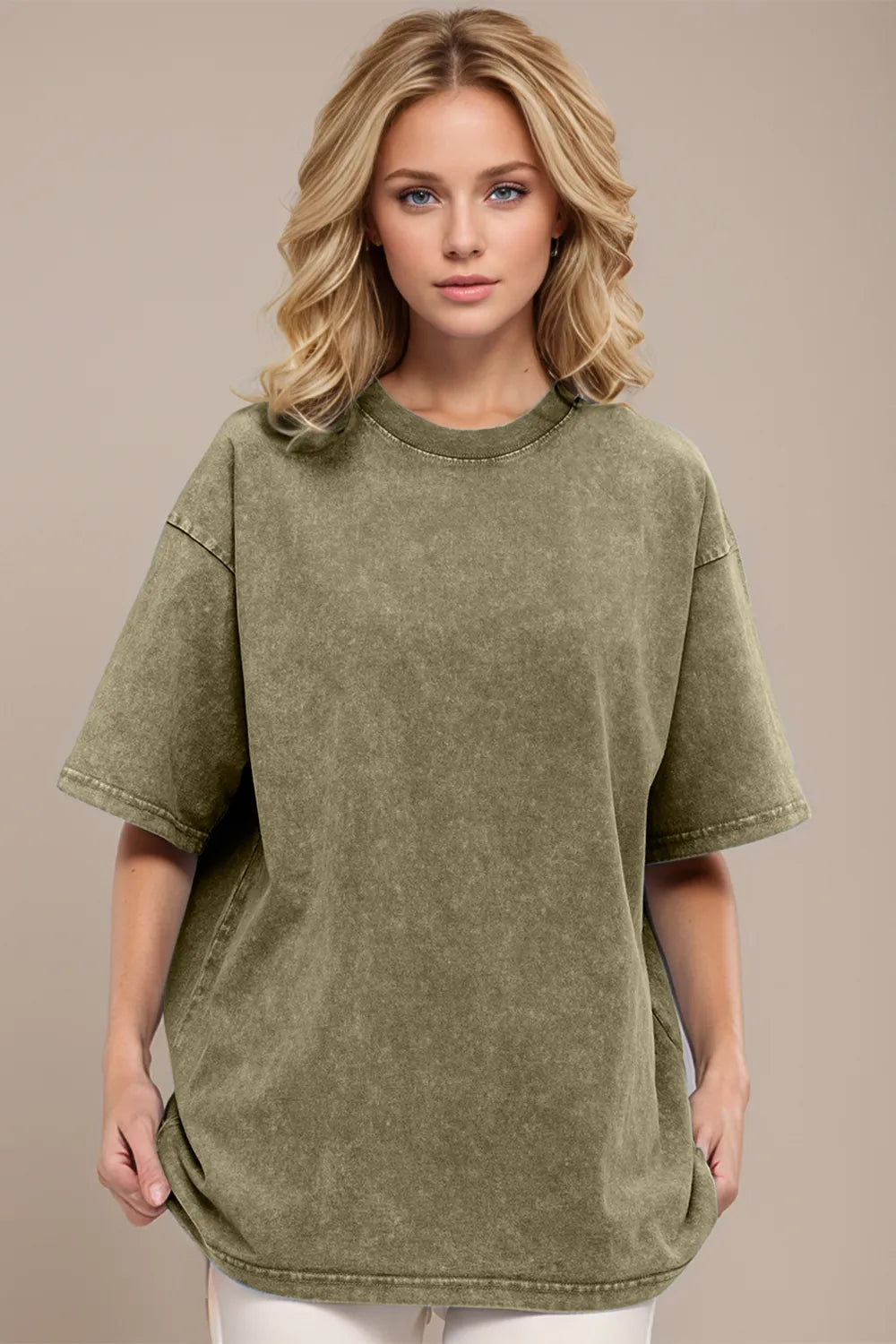 Woman wearing an olive green oversized t-shirt against a beige background