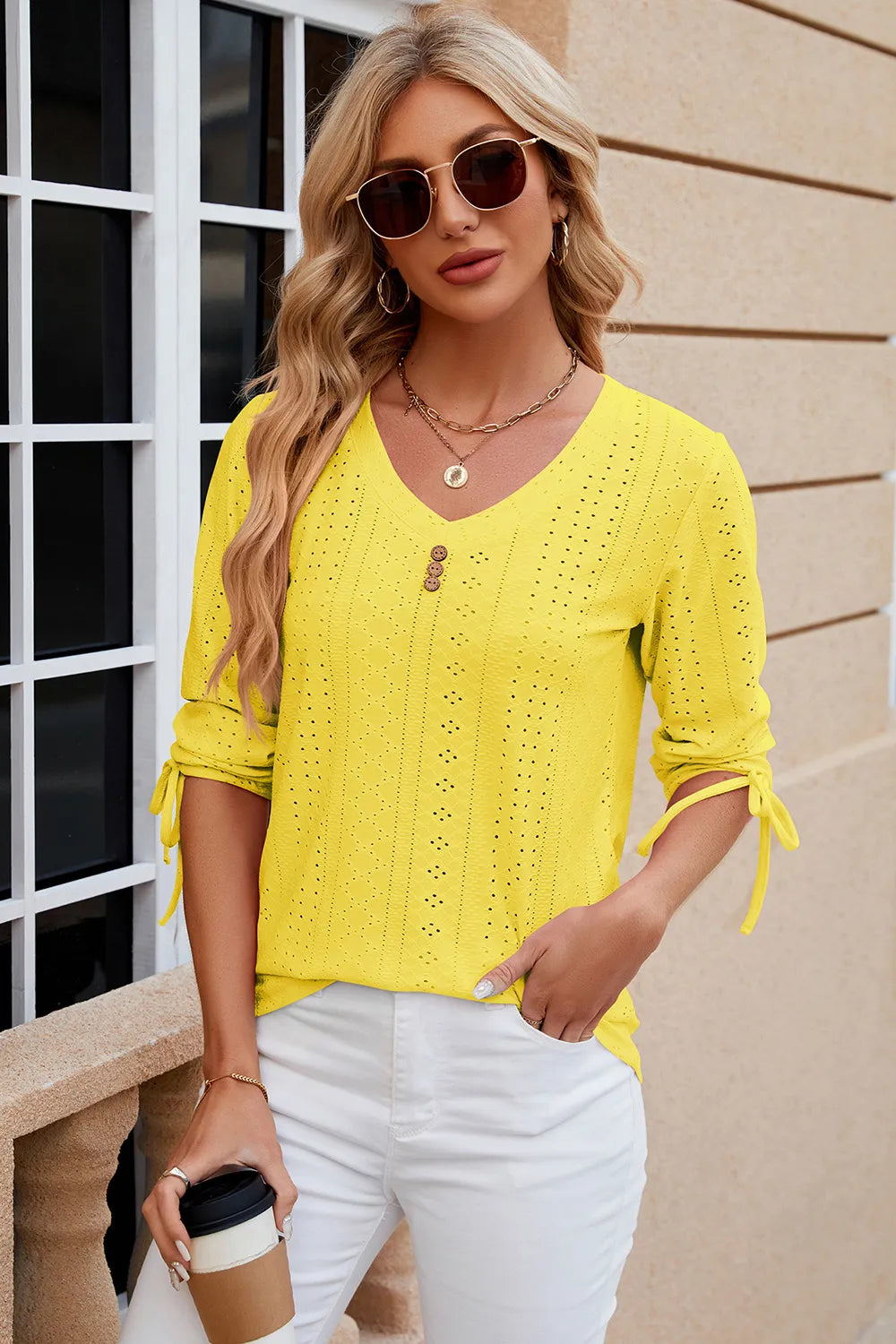 Yellow eyelet top with V neckline, half sleeves and fresh summer styling