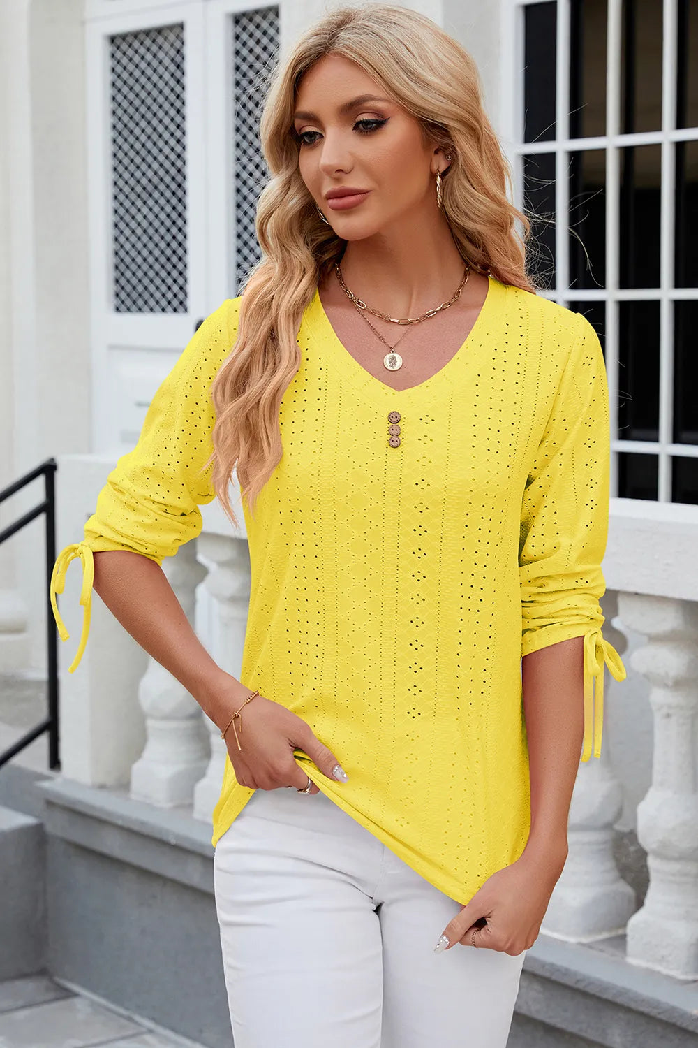 Yellow half sleeve blouse featuring eyelet embroidery and adjustable drawstring neckline