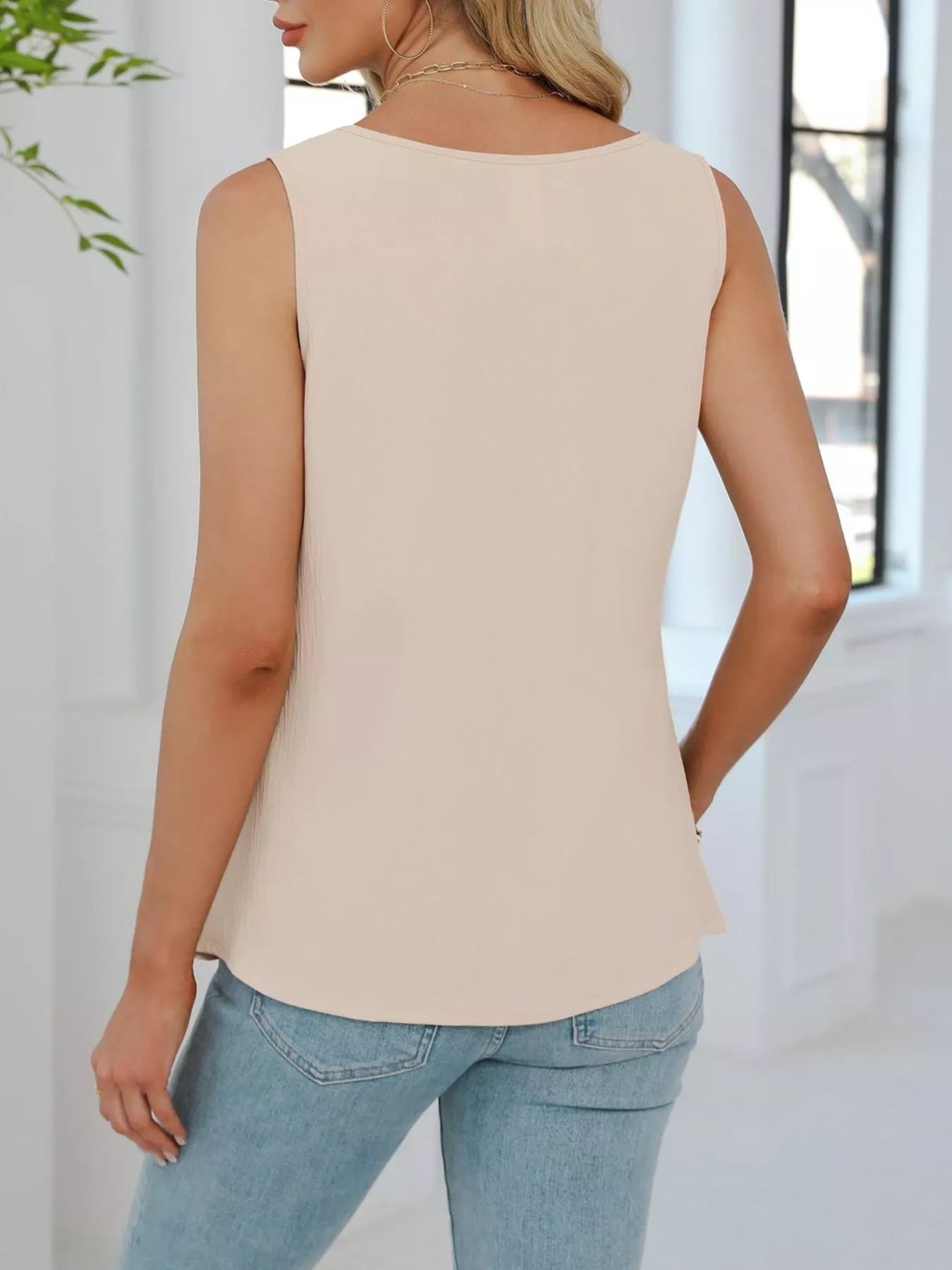 Back view of apricot sleeveless tank top with loose fit and clean minimalist design