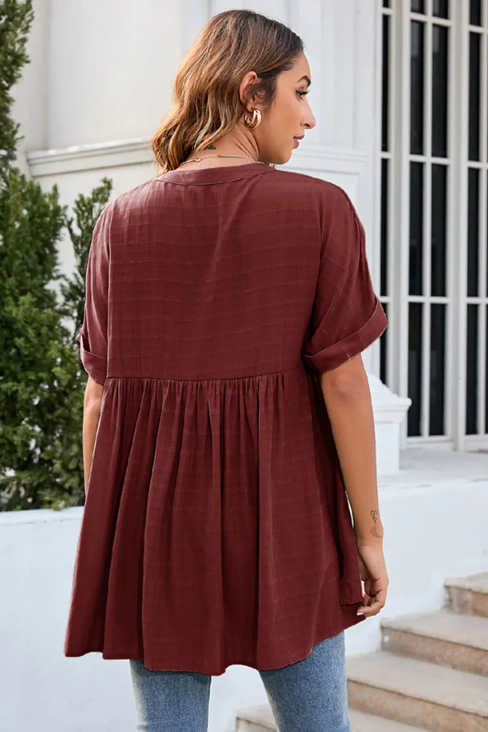 Back view of burgundy ruched short sleeve blouse showing flowy relaxed design