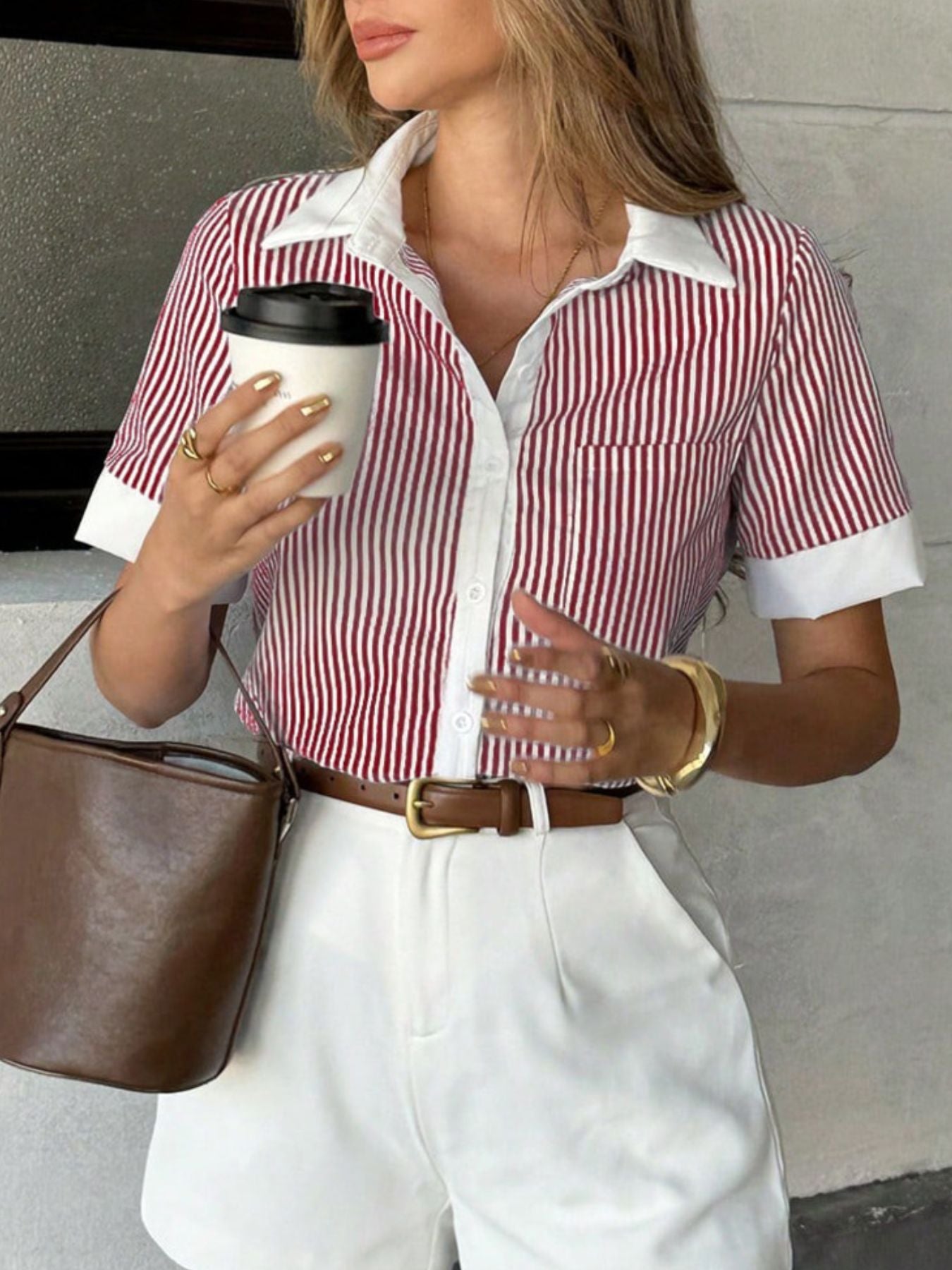 Burgundy striped pocket button down shirt styled with white shorts in casual seated pose
