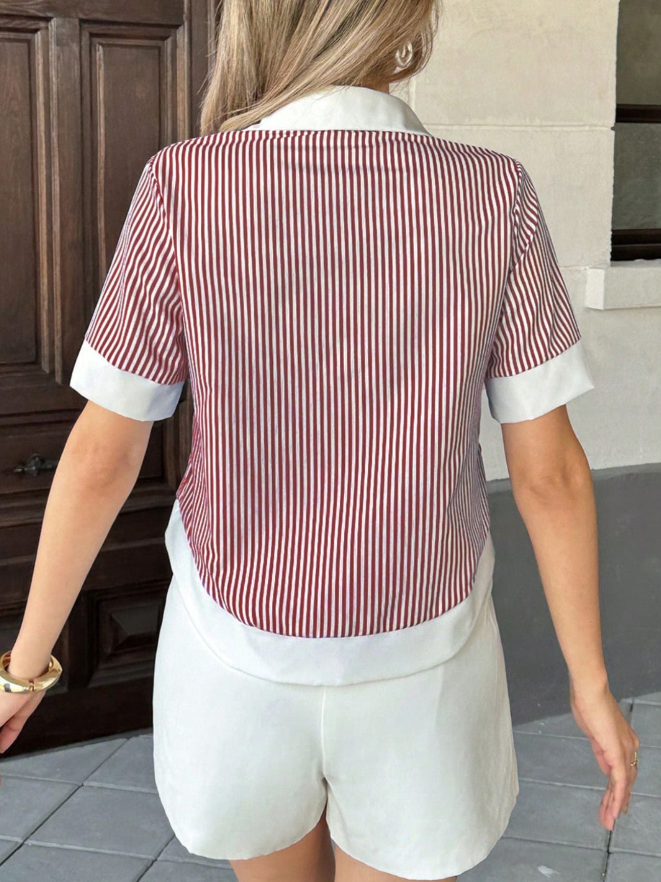 Side angle of burgundy striped pocket button down short sleeve shirt with relaxed silhouette