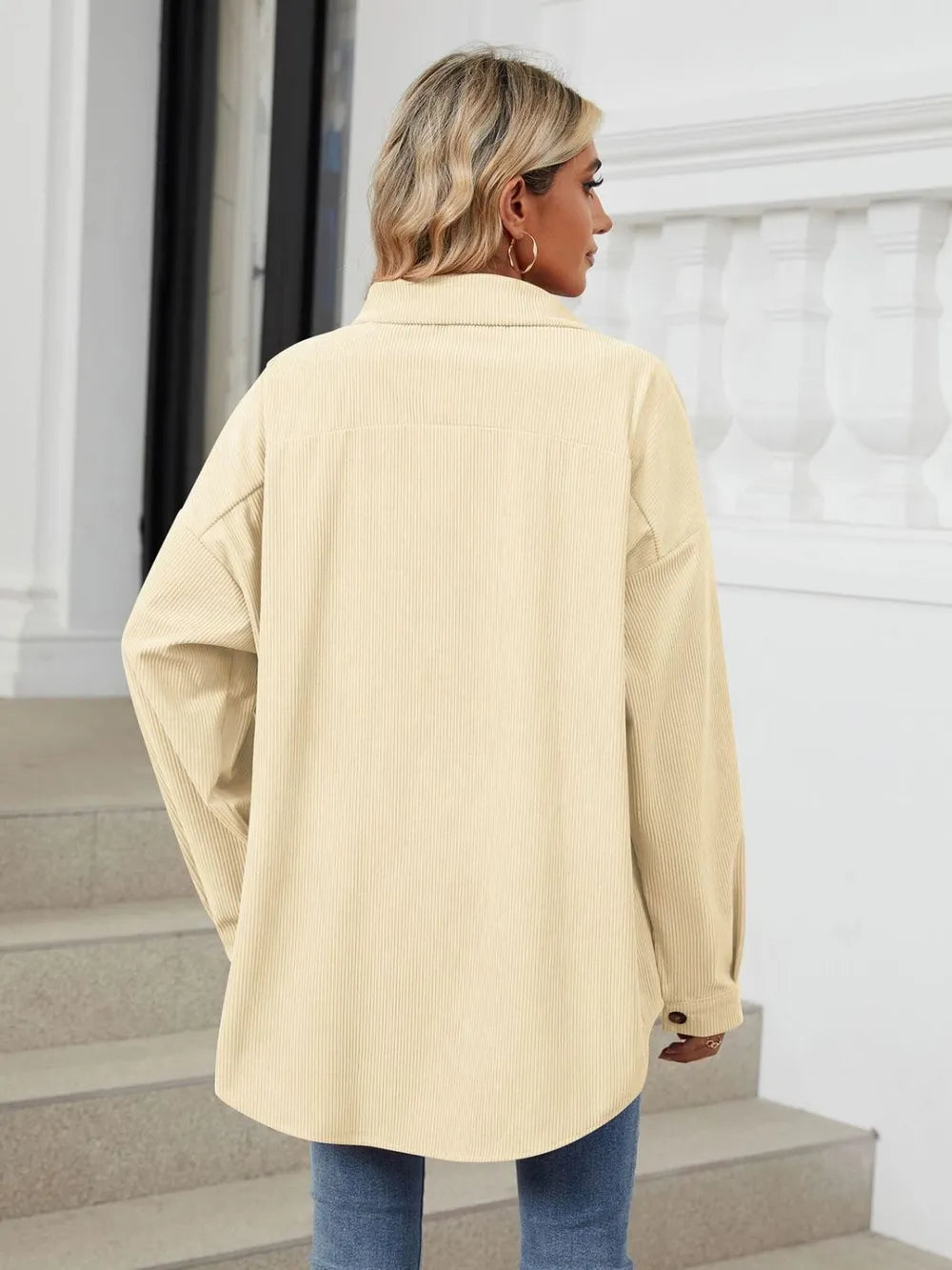 Back view of cream oversized collared shirt with long sleeves and relaxed design