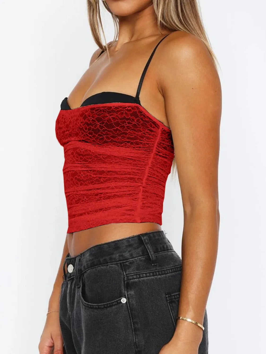 Side profile of a scarlet lace cami top with slim straps and a body-hugging fit