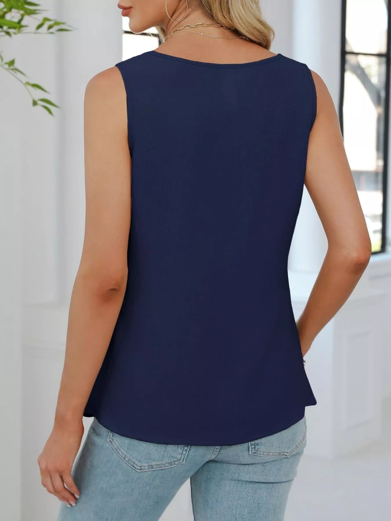 Back view of navy blue sleeveless tank top with relaxed silhouette and casual styling