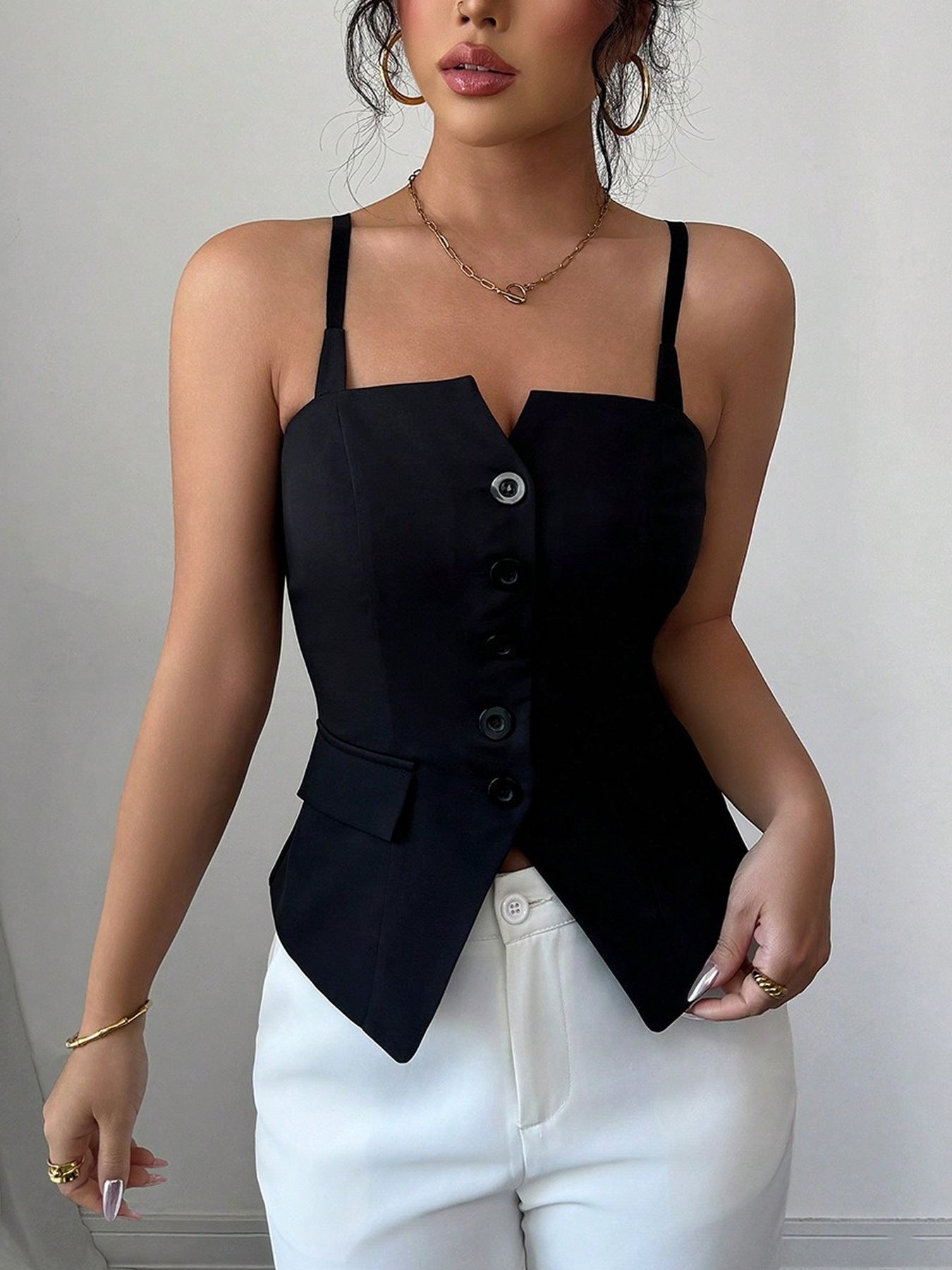 Women's black fitted cami top featuring a button-front design, slim straps, and a pointed hem, front view