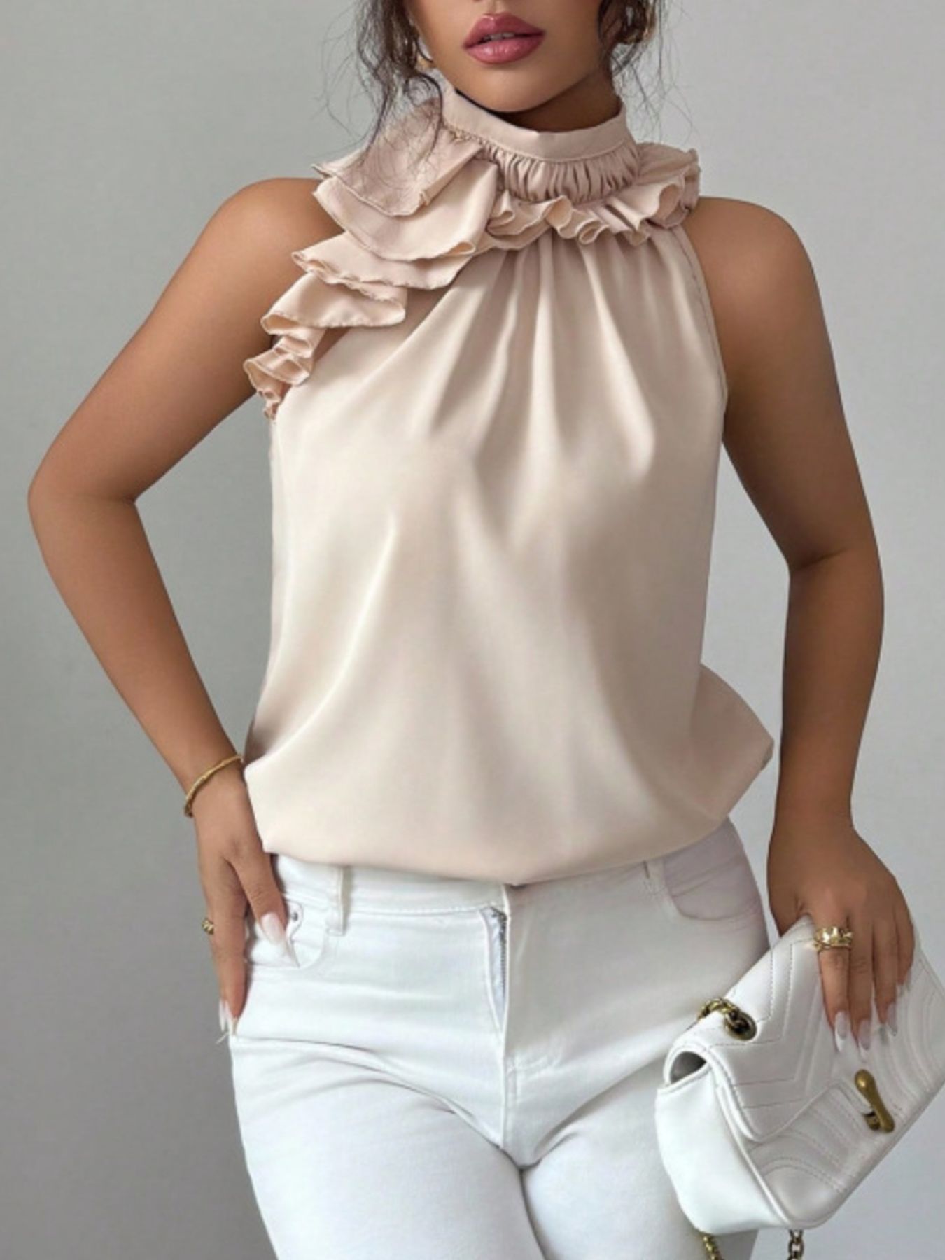 Cream ruffle high neck sleeveless button top styled with white shorts, casual look