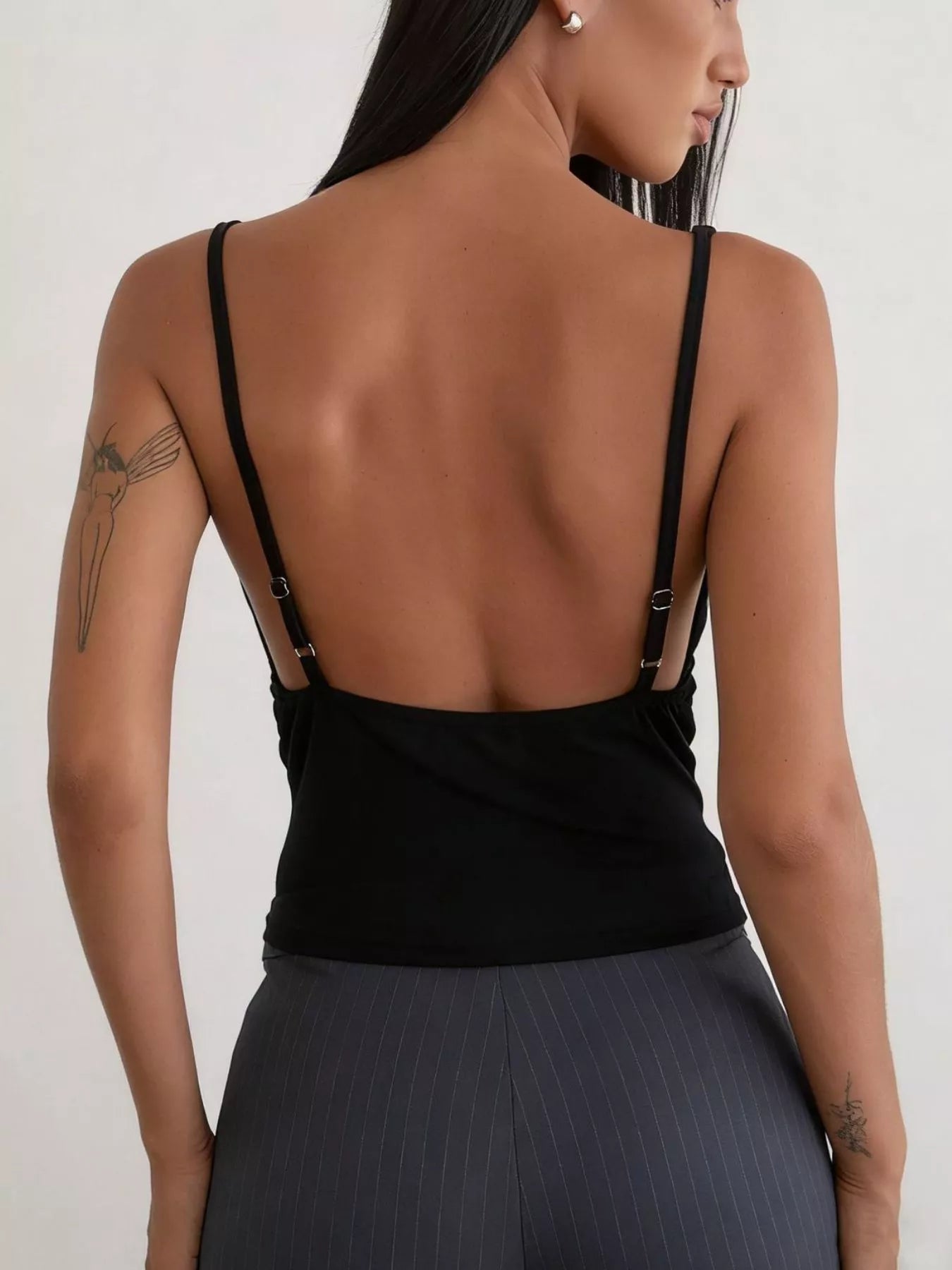 Women's black button-front fitted cami top with adjustable spaghetti straps and low-back design, shown from the back in a smart casual style.