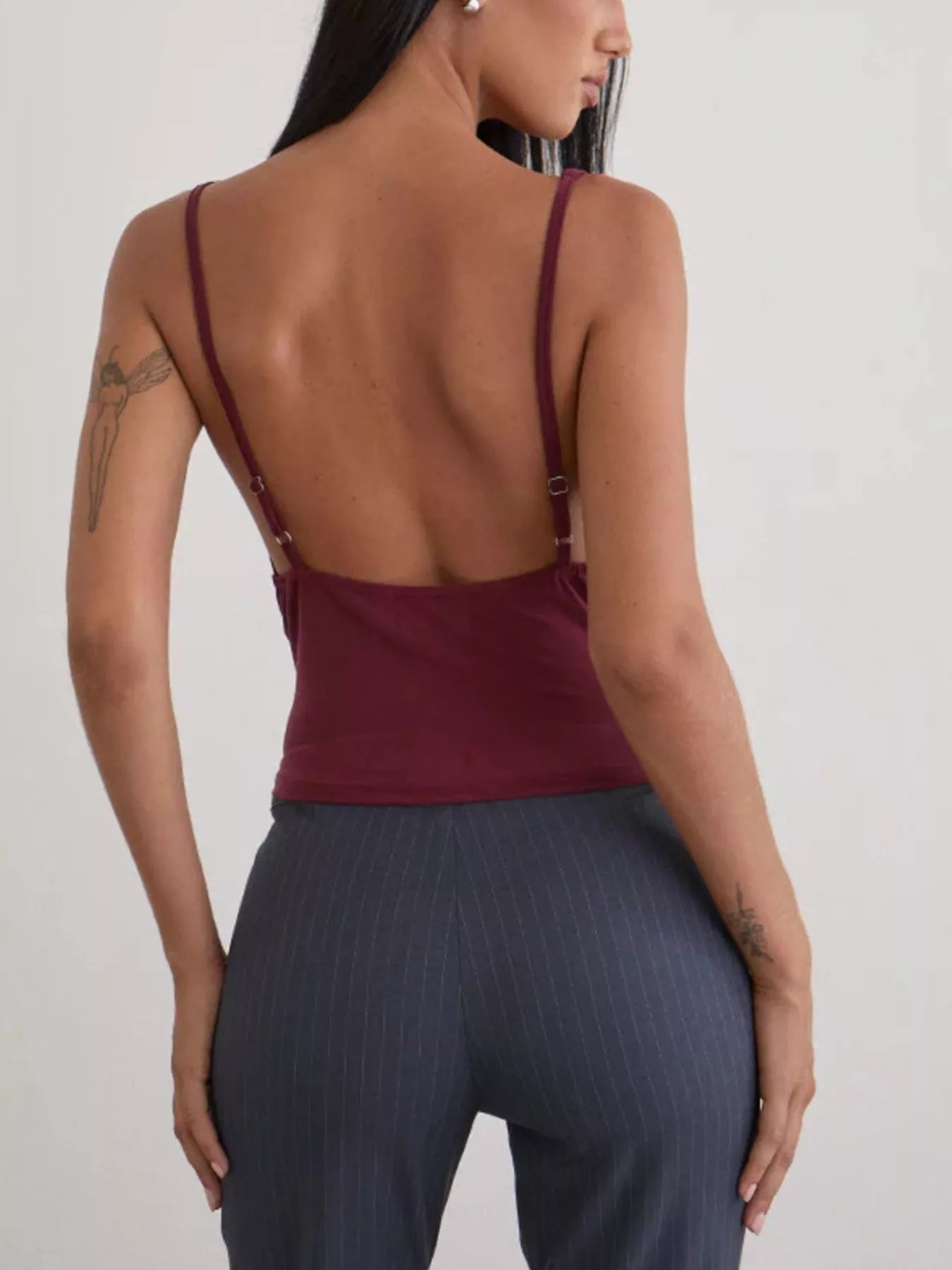 Women's burgundy fitted cami top with adjustable spaghetti straps and a low-back design, shown from the back in a smart casual style.
